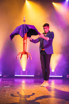 Professional magician performing trick with levitating table