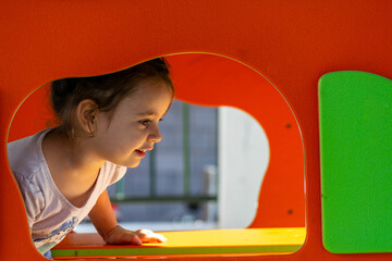 Games and Smiles: Happy Girl in the Orange House in the Patio