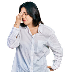 Beautiful hispanic woman wearing casual white shirt tired rubbing nose and eyes feeling fatigue and headache. stress and frustration concept.