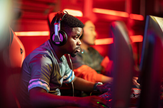 Professional cybersport gamer wearing headphones participating in E-Sports Tournament