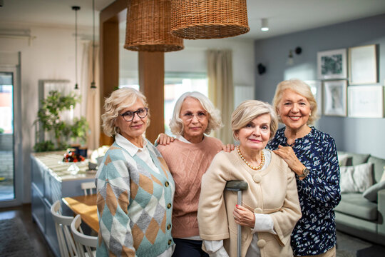 Group of senior women standing in the living room at home