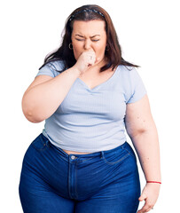 Young plus size woman wearing casual clothes feeling unwell and coughing as symptom for cold or bronchitis. health care concept.