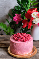 Obraz na płótnie Canvas raspberry cake with raspberry cheesecake layer. Decorated with raspberry. Side view.