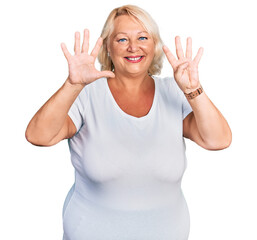 Middle age blonde woman wearing casual white t shirt showing and pointing up with fingers number nine while smiling confident and happy.