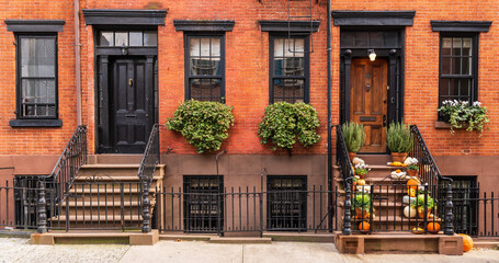 Typical Greenwich Village houses in New York with entrance staircase and wooden doors - obrazy, fototapety, plakaty