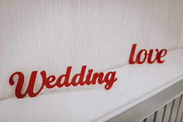 Foam inscriptions with the words wedding and love on the background of the wall. Photography, copy space.