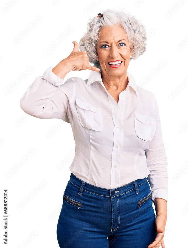 Wall mural Senior grey-haired woman wearing casual clothes smiling doing phone gesture with hand and fingers like talking on the telephone. communicating concepts.