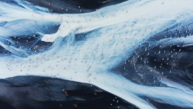 Aerial view of Iceland's frozen river textures