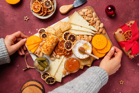 Holiday cheese board assortment with nuts and gifts