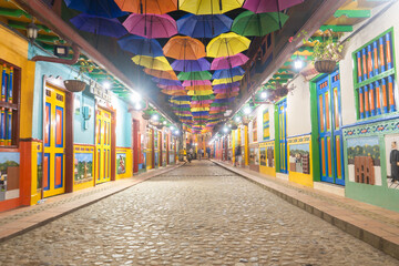 Colourful streets of Guatape, Colombia at night. Painted walls, colourful doors.