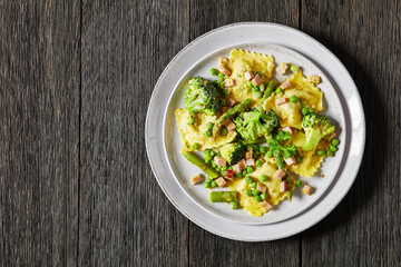ravioli primavera with ham on a grey plate