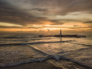sunset on the beach with lighthouse