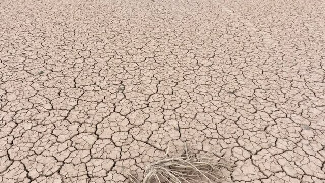 Aerial shot looking down at the cracked surface of a dry lake in Navada