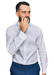 Young man with beard wearing business shirt looking stressed and nervous with hands on mouth biting nails. anxiety problem.