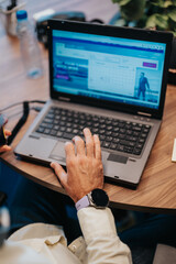 Senior business person analyzing market data and networking in a modern co-work space. Experienced in stock market analysis for profitable investments. Focused on individual tasks in a start-up office