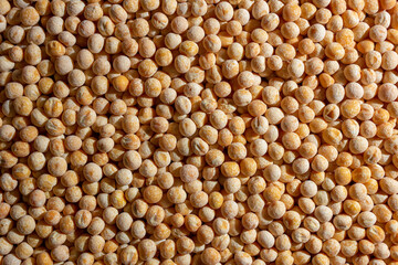 Uncooked Yellow Polished Peas Background. A Culinary Canvas of Dry Yellow Peas, Creating a Lively and Textured Background for Gourmet Cooking. Scattered Raw Polished Peas. Healthy Eating Ingredients