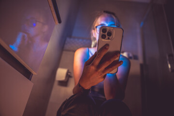 Watching your phone in the toilet. Phone addiction.