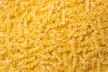 Uncooked Fusilli Pasta: A Culinary Canvas of Spiral Macaroni, Creating a Lively and Textured Background for Gourmet Cooking. Dry Pasta. Raw Macaroni - Top View, Flat Lay