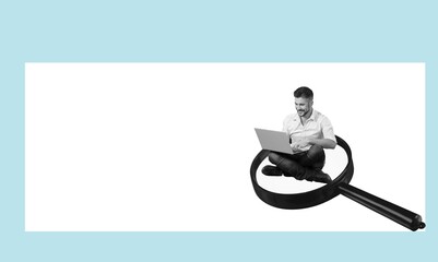 A business person with a laptop on a magnifying glass.