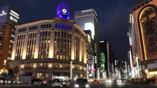 GINZA, TOKYO, JAPAN - NOV 2023 : Sunset to night, time lapse shot of Ginza area. Upmarket shopping and entertainment district, featuring numerous department stores, restaurants, night clubs and cafes.