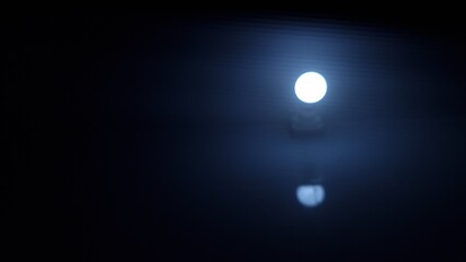 Bokeh of the light bulb on a black night background. Abstract background.