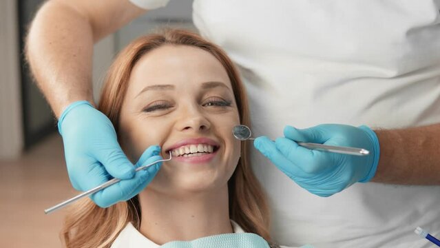 The patient confidently trusts the specialist and understands the importance of regular visits to the dentist. A dentist provides competent advice and recommendations on dental health. Smiling.