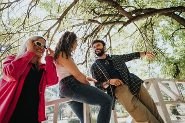Cheerful Caucasian adults enjoying a carefree day in the park. Laughing and socializing, they...