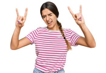 Young hispanic woman wearing casual clothes shouting with crazy expression doing rock symbol with hands up. music star. heavy concept.