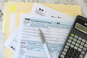 Filling out income tax form paperwork, filing taxes - obrazy, fototapety, plakaty