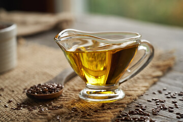 Flax seed oil in a glass jug on a table