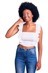 Young african american woman wearing casual clothes smiling doing phone gesture with hand and fingers like talking on the telephone. communicating concepts.