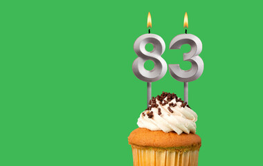 Birthday card with candle number 83 - Cupcake on green background