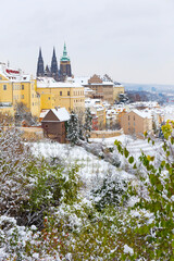 Obraz premium Snowy Prague City with gothic Castle from the Hill Petrin, Czech republic