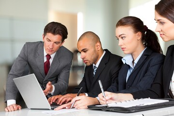 Successful happy business team at meeting in office.