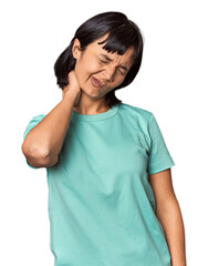 Young Hispanic woman with short black hair in studio having a neck pain due to stress, massaging and touching it with hand.