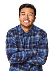 Young Chinese man in studio background laughing and having fun.