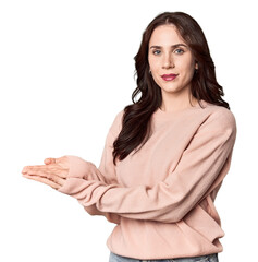 Young Caucasian woman in a studio setting holding a copy space on a palm.