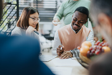 A diverse group collaborates on business strategies in a modern office setting. They analyze data and plan for growth, innovation, and market expansion, aiming for profit and sustainability.