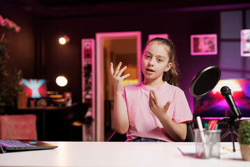 Gen Z internet star filming family vlog in home studio, talking about day at school with children...