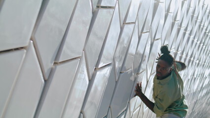 Active guy moving abstract wall. Dancer expressing feelings through choreography