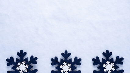 winter border with snow background and dark blue and white snowflake ornaments