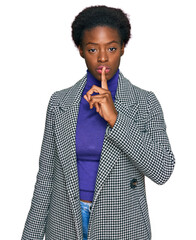 Young african american girl wearing casual clothes asking to be quiet with finger on lips. silence...