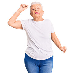 Senior beautiful woman with blue eyes and grey hair wearing casual white tshirt stretching back, tired and relaxed, sleepy and yawning for early morning