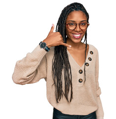 African american woman wearing casual clothes smiling doing phone gesture with hand and fingers like talking on the telephone. communicating concepts.