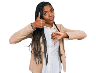 African american woman wearing business jacket doing thumbs up and down, disagreement and agreement expression. crazy conflict
