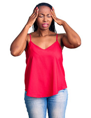 Obraz na płótnie Canvas Young african american woman wearing casual clothes with hand on head for pain in head because stress. suffering migraine.