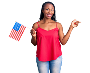 Young african american woman holding united states flag smiling happy pointing with hand and finger to the side