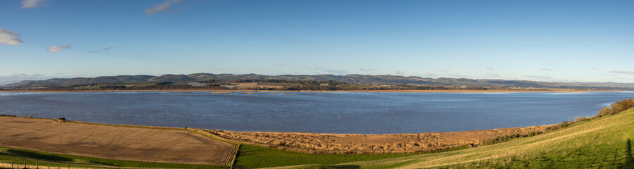 very wide panoramic view of the Firth of Tay from the south bank looking north.