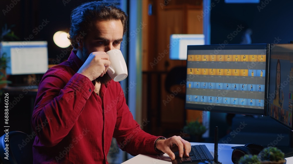 Aufkleber photographer using software on computer to perform editing operations, enjoying cup of coffee while 