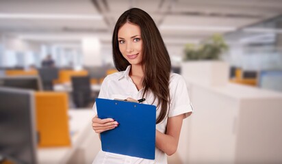 Happy business woman at work in office.
